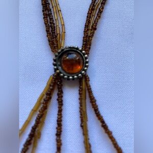 Amber glass bead multi strand necklace featured a central large stone
